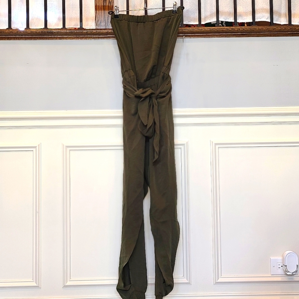 Akira green jumpsuit with open slit pants that tie.